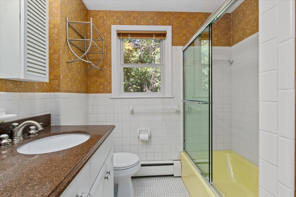 44 Ellis Street Medway, MA 02053 - Photo 31 of 42 a bathroom with a sink and mirror with bathtub