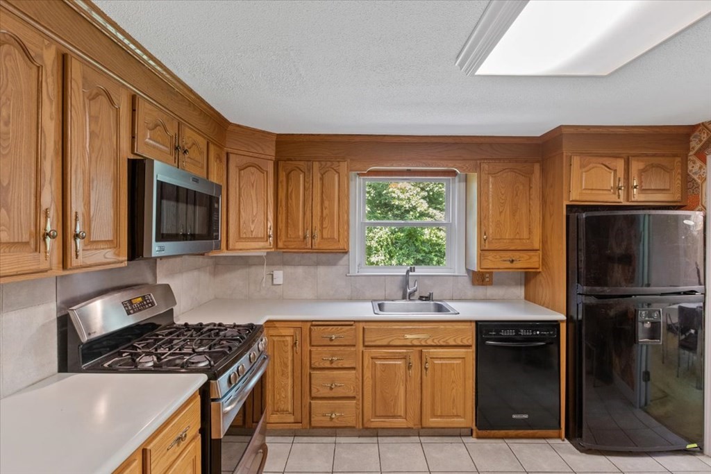 44 Ellis Street Medway, MA 02053 - Photo 9 of 42 a kitchen with stainless steel appliances granite countertop a sink stove and refrigerator