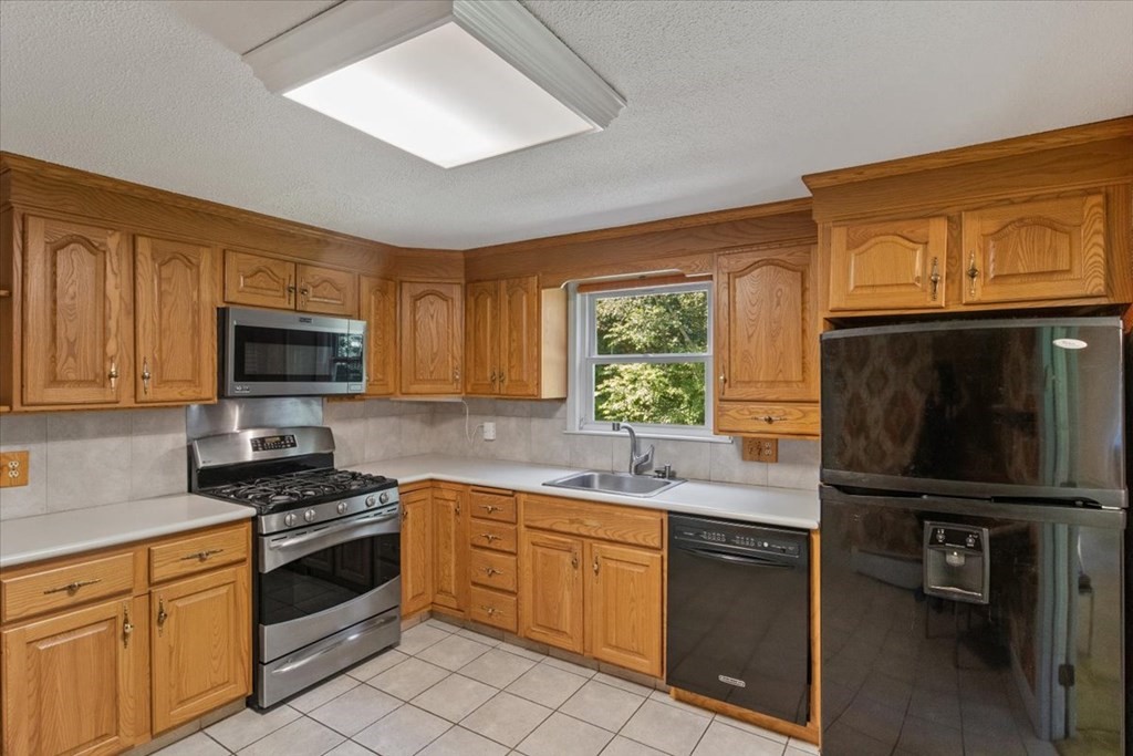 44 Ellis Street Medway, MA 02053 - Photo 10 of 42 a kitchen with a sink stove and microwave