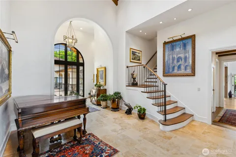 a living room with furniture a piano and a window