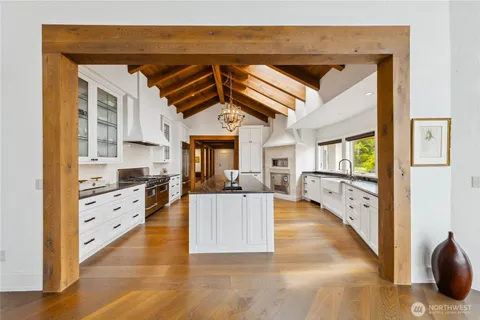 a view of a kitchen with cabinets and wooden floor