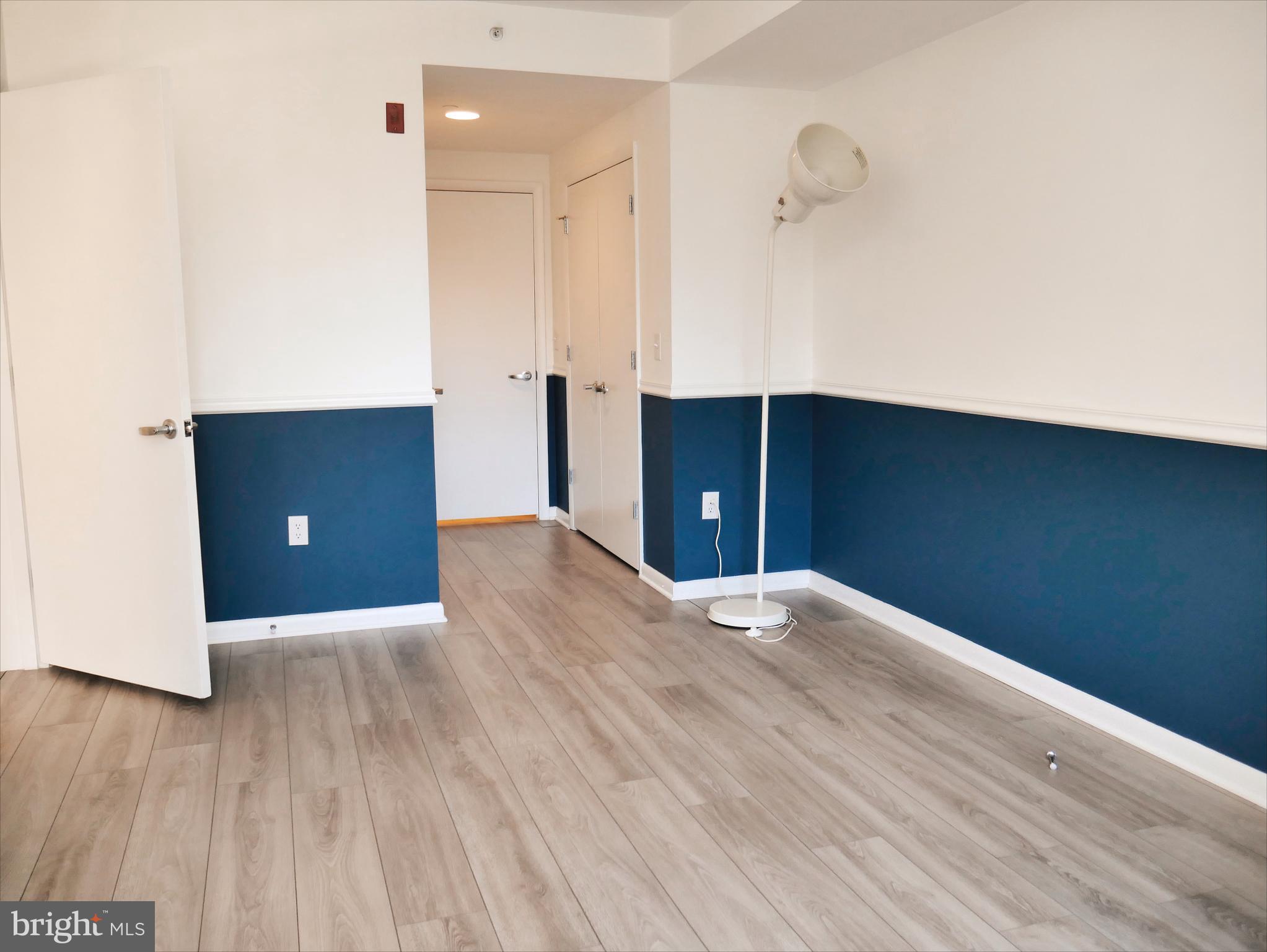 350 G Street Southwest, Unit N501 Washington, DC 20024 - Photo 12 of 49 an empty room with wooden floor and cabinet