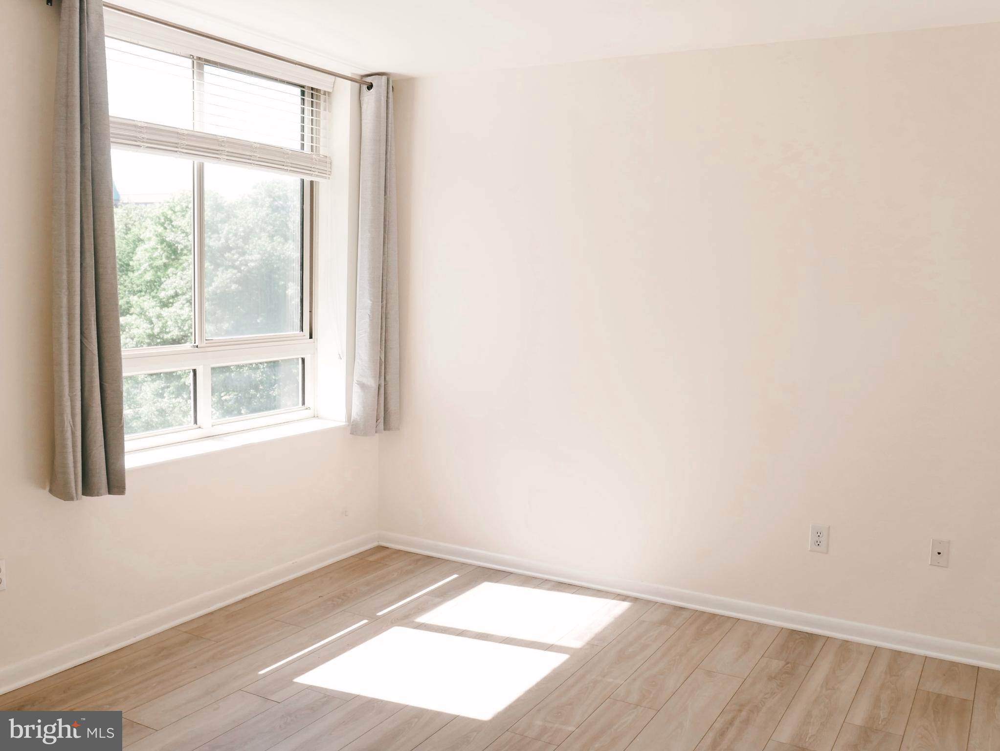 350 G Street Southwest, Unit N501 Washington, DC 20024 - Photo 15 of 49 a view of an empty room with wooden floor and a window