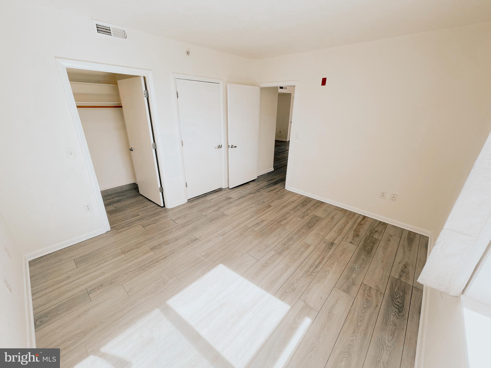 350 G Street Southwest, Unit N501 Washington, DC 20024 - Photo 19 of 49 an empty room with wooden floor and closet