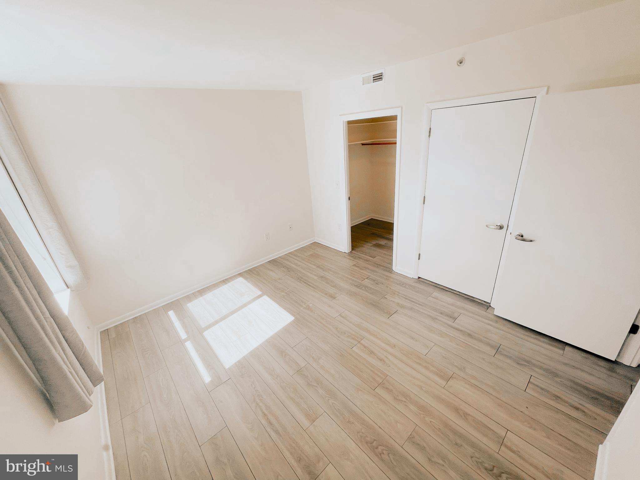 350 G Street Southwest, Unit N501 Washington, DC 20024 - Photo 20 of 49 an empty room with wooden floor and windows