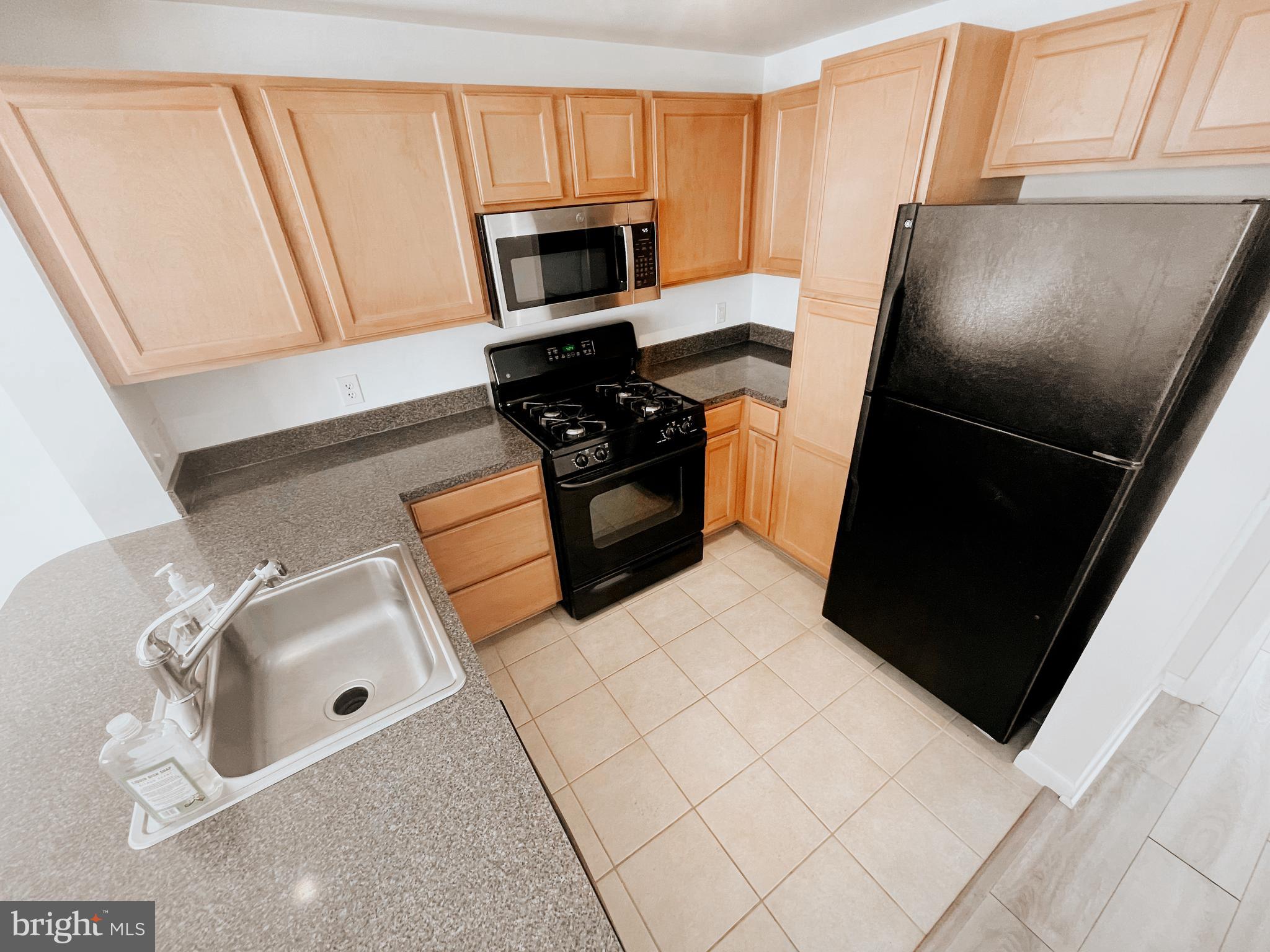 350 G Street Southwest, Unit N501 Washington, DC 20024 - Photo 28 of 49 a kitchen with a refrigerator and a stove