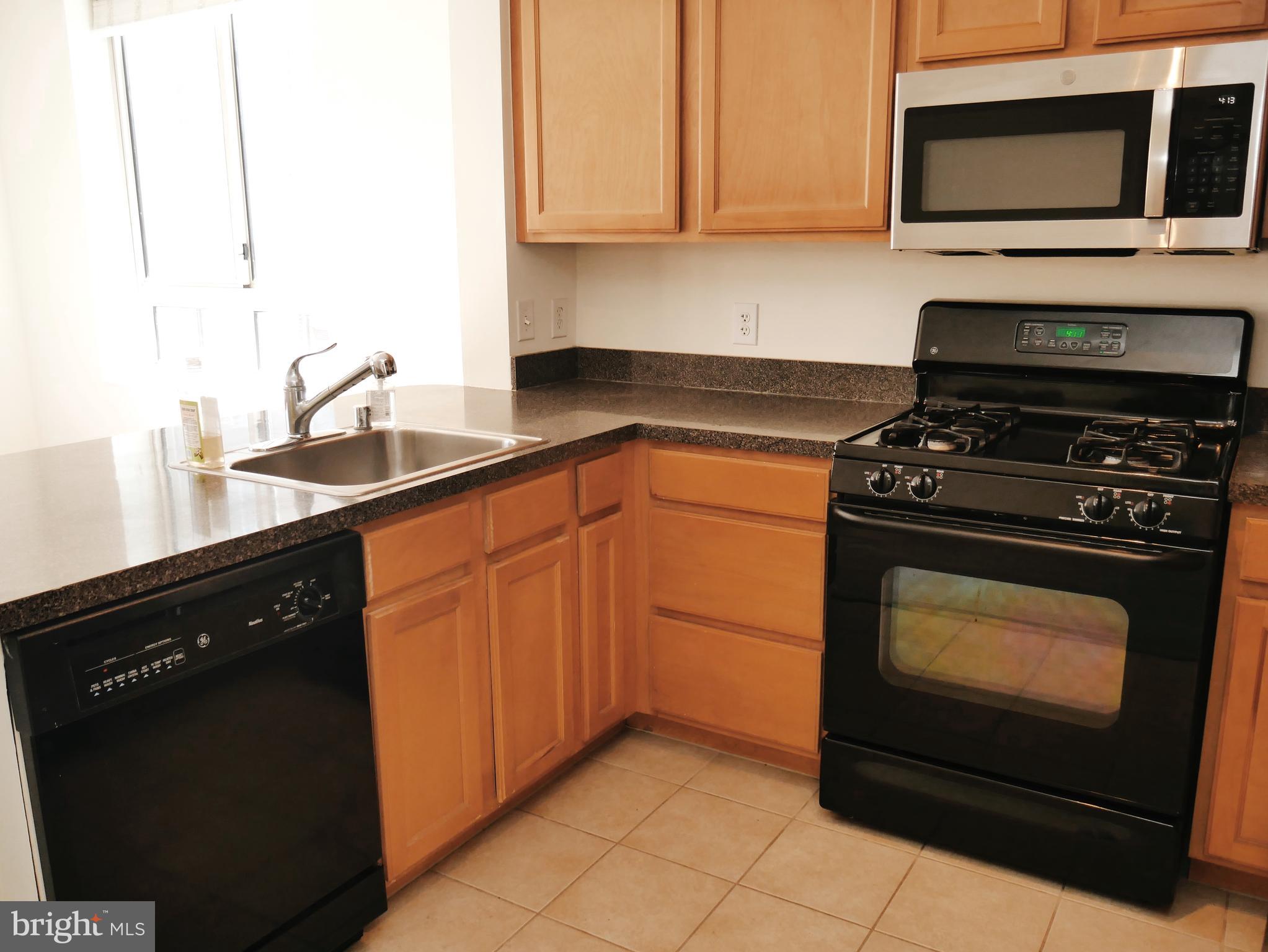 350 G Street Southwest, Unit N501 Washington, DC 20024 - Photo 29 of 49 a kitchen with granite countertop cabinets and steel stainless steel appliances