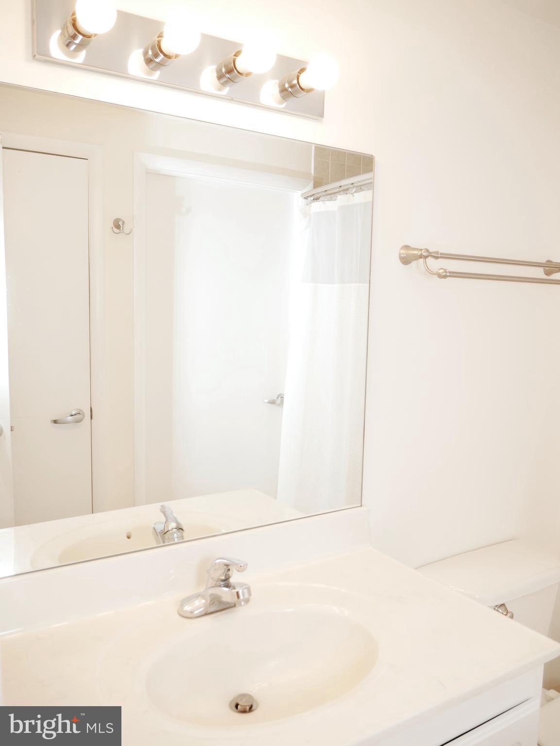 350 G Street Southwest, Unit N501 Washington, DC 20024 - Photo 40 of 49 a bathroom with a sink and a mirror