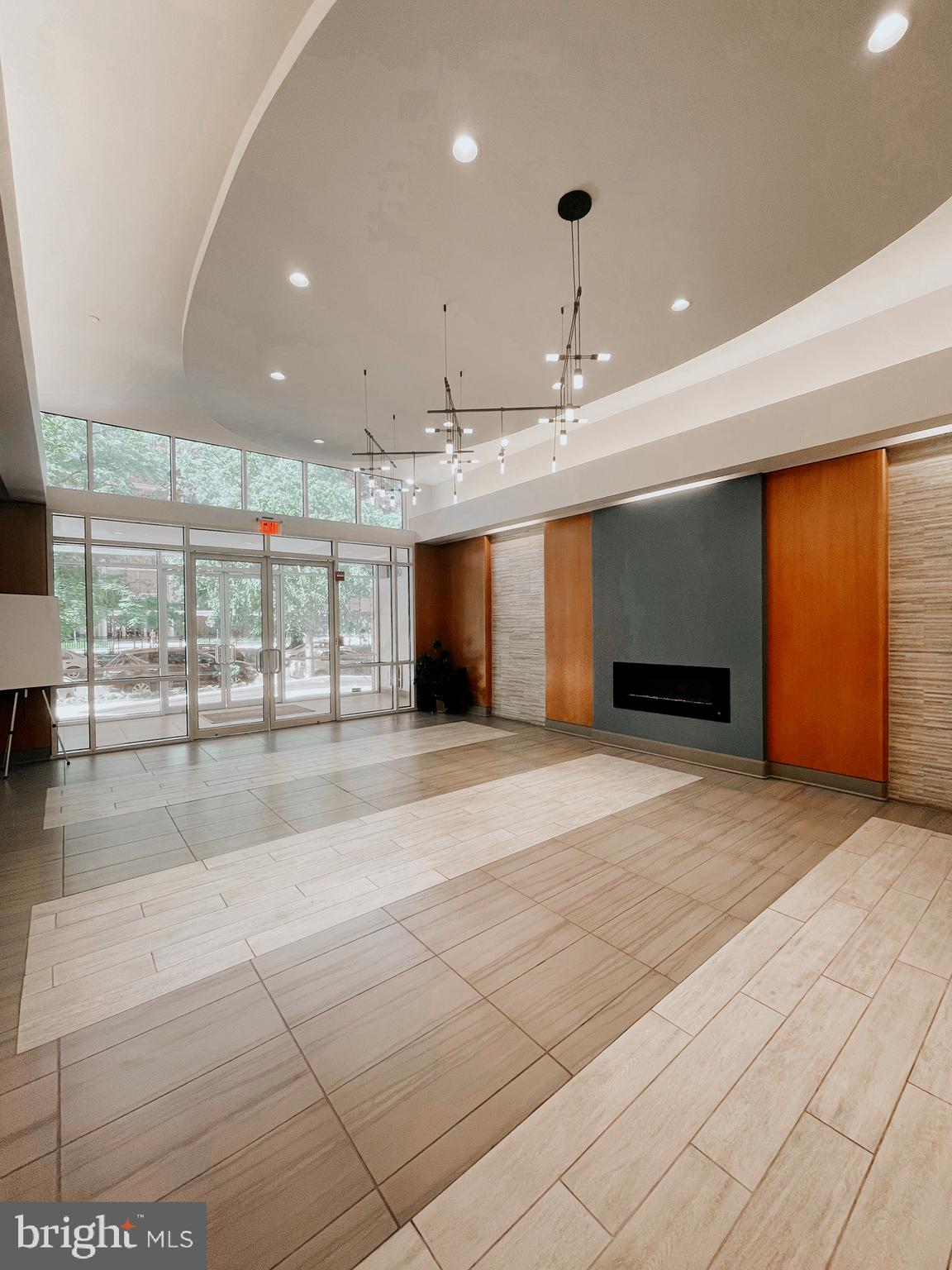 350 G Street Southwest, Unit N501 Washington, DC 20024 - Photo 5 of 49 a view of an empty room with kitchen and a window