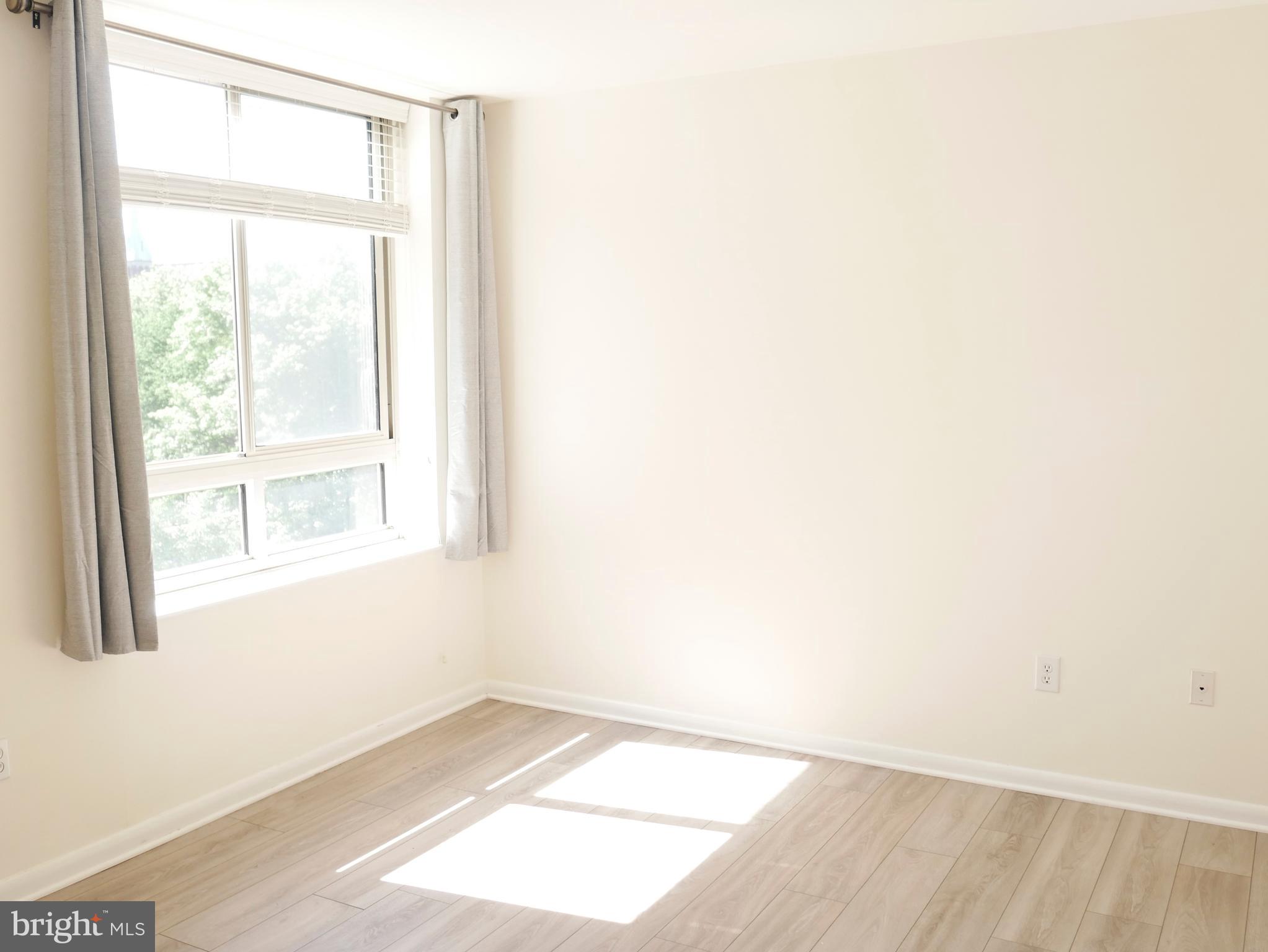 350 G Street Southwest, Unit N501 Washington, DC 20024 - Photo 10 of 49 a view of an empty room with wooden floor and a window