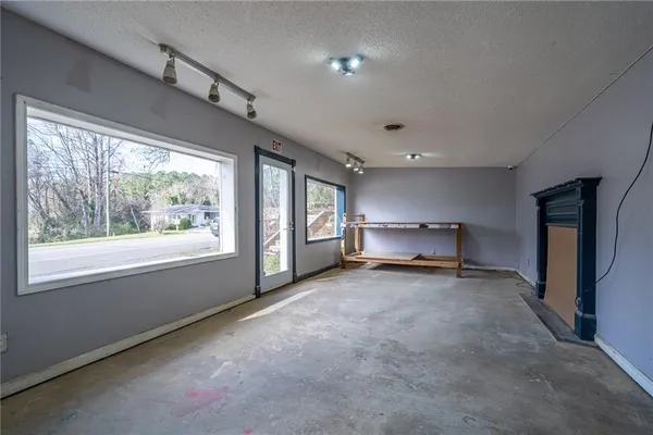a view of a livingroom with a ceiling fan and window