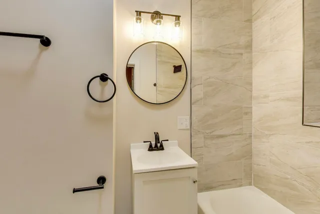 a bathroom with a sink a toilet and a shower