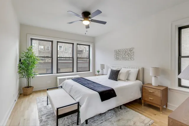 a bedroom with a large bed and a large window