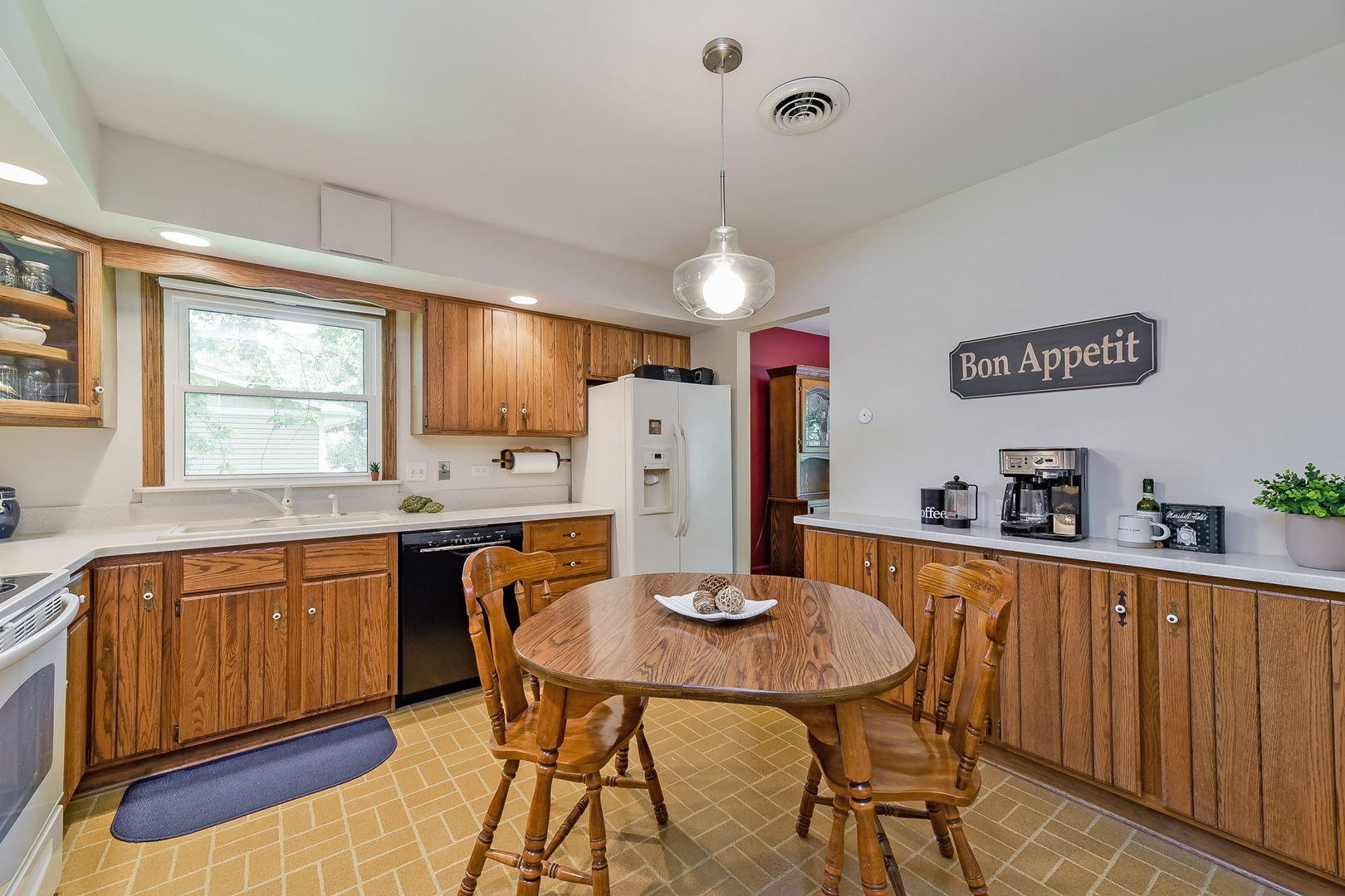 N150 County Farm Road Winfield, IL 60190 - Photo 6 of 22 a kitchen with stainless steel appliances kitchen island granite countertop a dining table chairs and a refrigerator