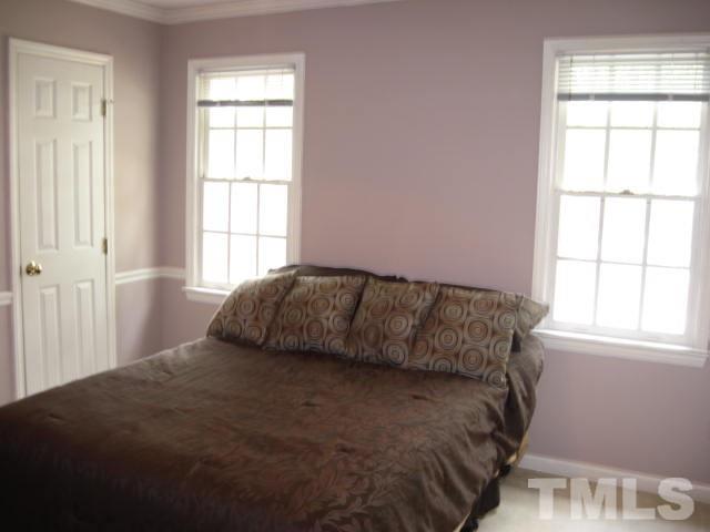 3537 Singleleaf Lane Raleigh, NC 27616 - Photo 16 of 21 a bedroom with a bed and window