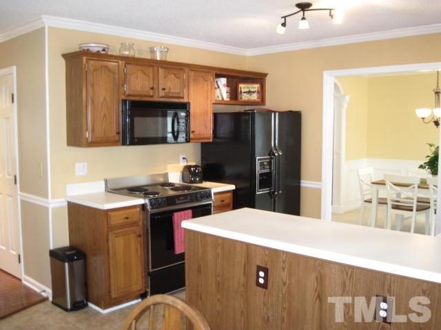 3537 Singleleaf Lane Raleigh, NC 27616 - Photo 3 of 21 a kitchen with stainless steel appliances kitchen island a stove a refrigerator and a refrigerator with wooden floor