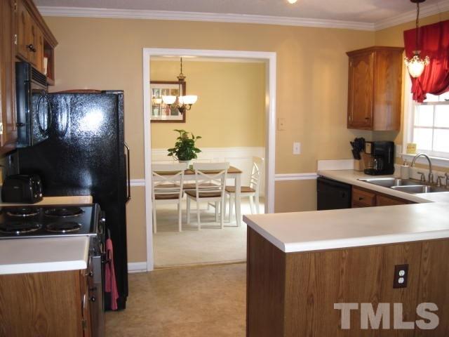 3537 Singleleaf Lane Raleigh, NC 27616 - Photo 4 of 21 a kitchen with a sink a stove and a refrigerator