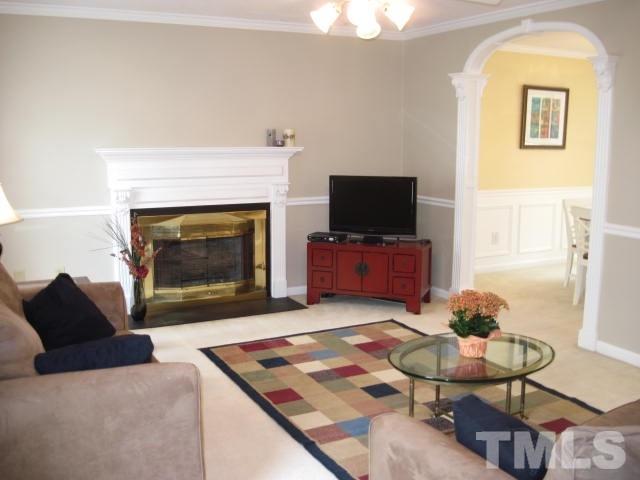 3537 Singleleaf Lane Raleigh, NC 27616 - Photo 9 of 21 a living room with furniture a fireplace and a flat screen tv