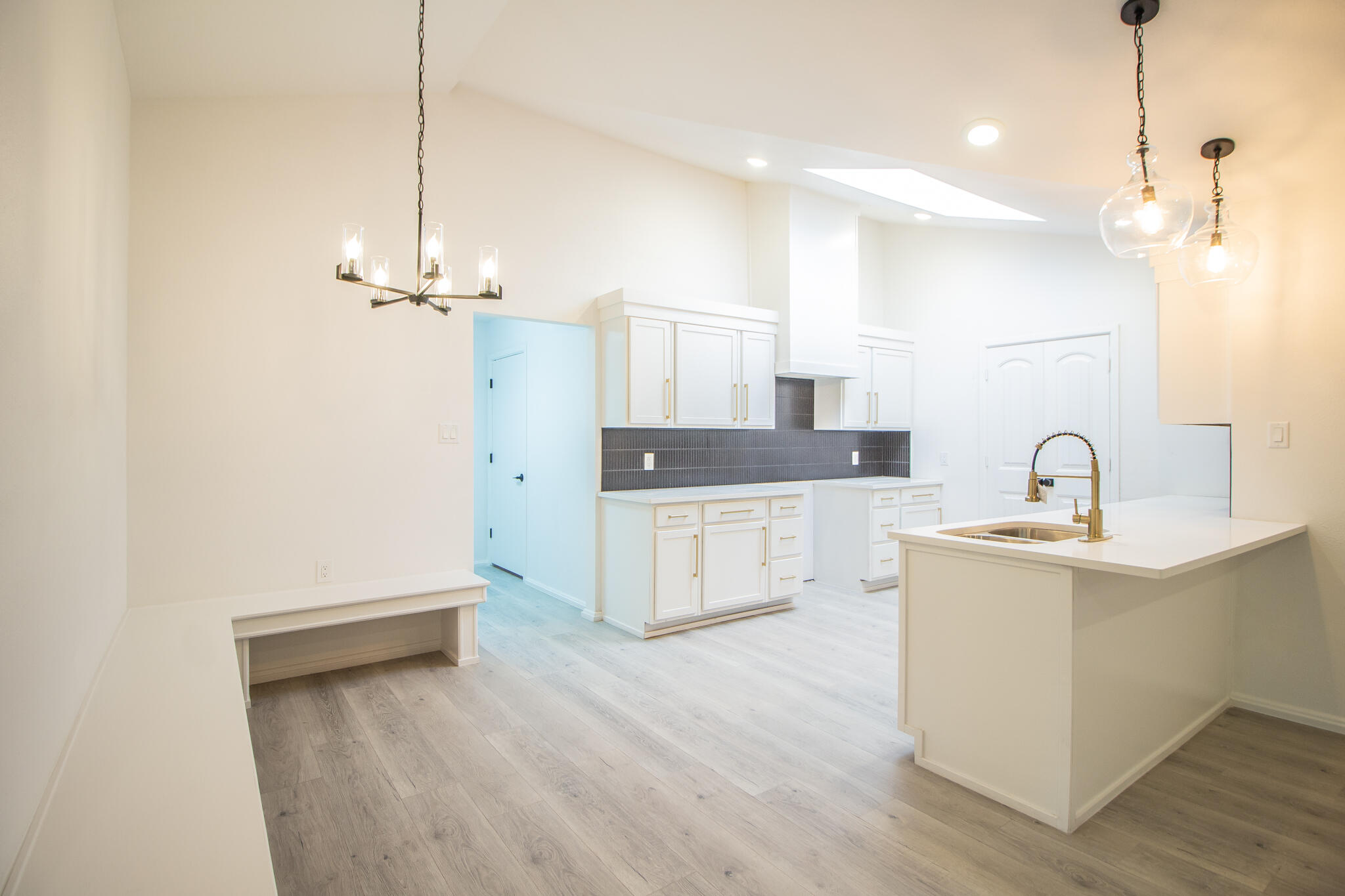 3602 63rd Drive Lubbock, TX 79413 - Photo 12 of 33 a large white kitchen with a sink a stove and refrigerator