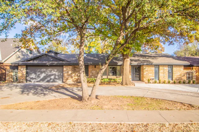 a front view of a building with a tree
