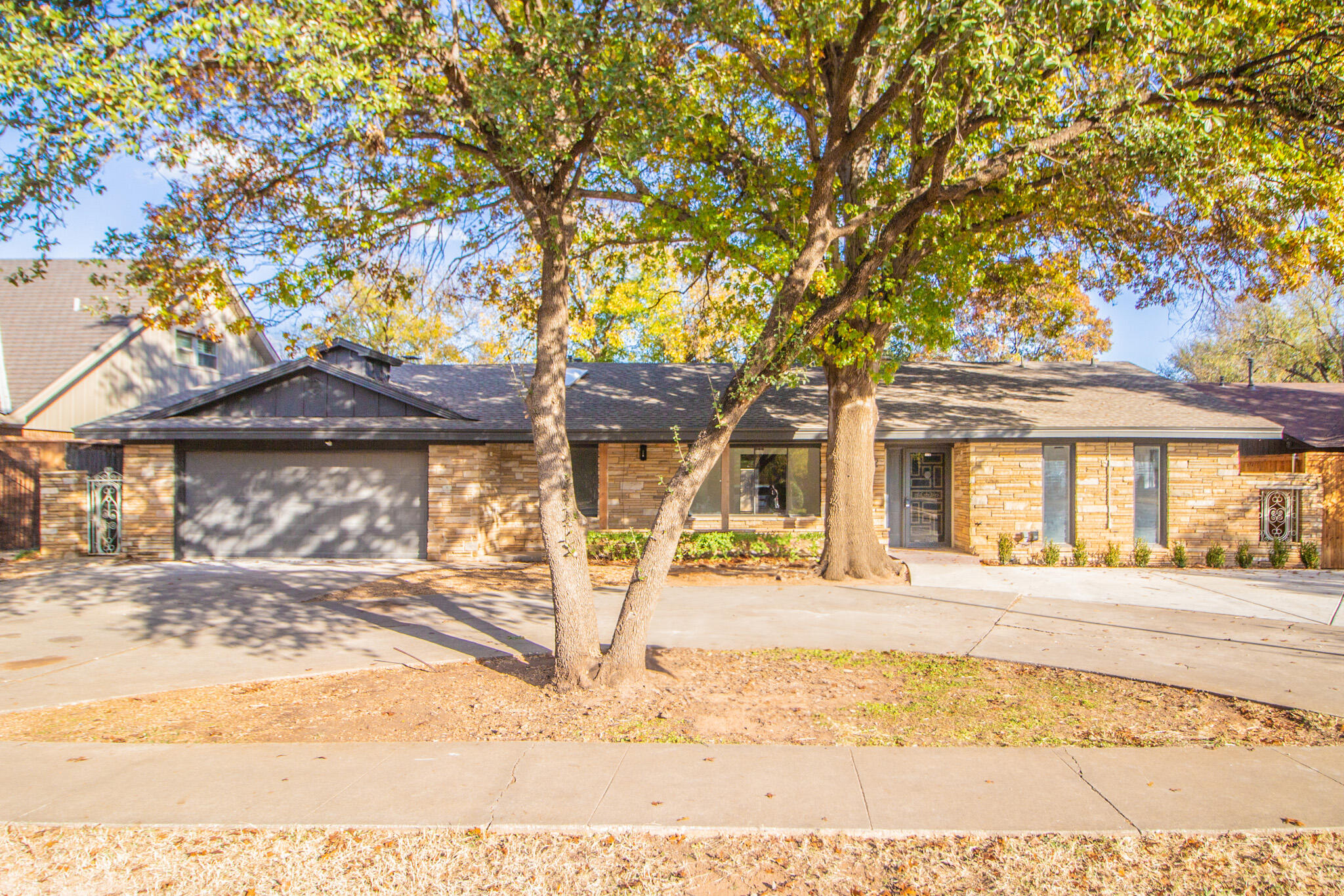3602 63rd Drive Lubbock, TX 79413 - Photo 2 of 33 a front view of a building with a tree