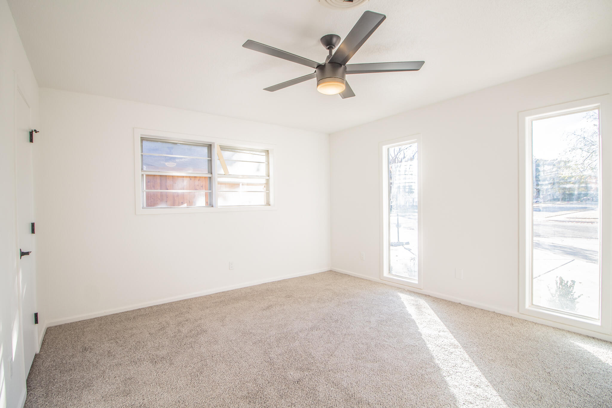 3602 63rd Drive Lubbock, TX 79413 - Photo 21 of 33 a view of a big room with windows and a ceiling fan