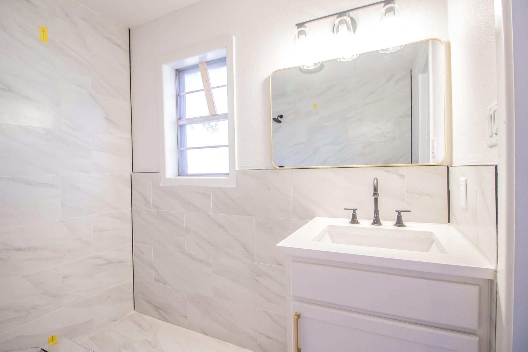 3602 63rd Drive Lubbock, TX 79413 - Photo 27 of 33 a bathroom with a sink and a mirror