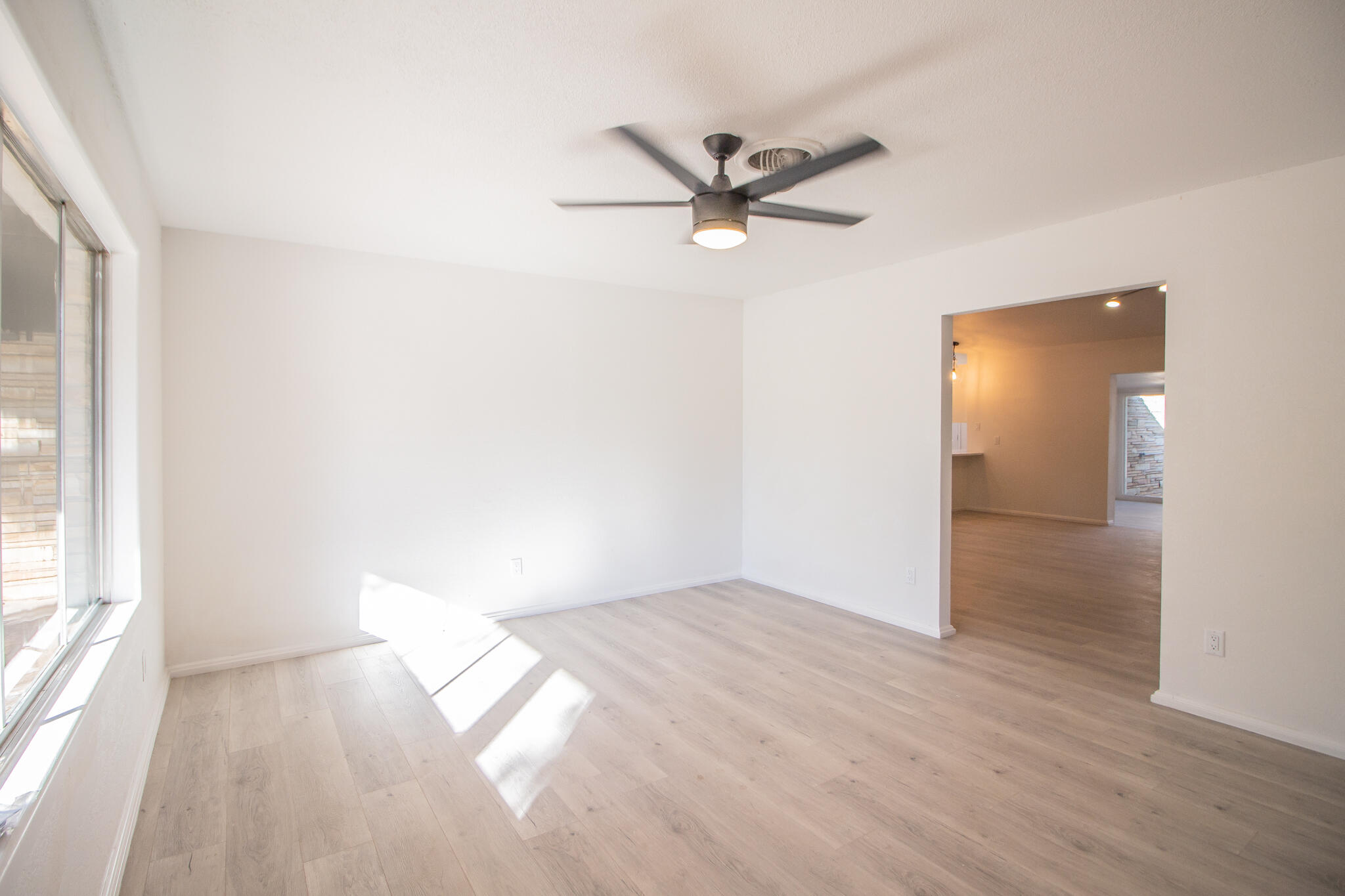 3602 63rd Drive Lubbock, TX 79413 - Photo 6 of 33 a view of a big room with wooden floor and windows in a room