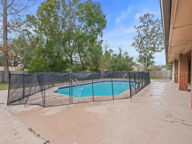 a view of a swimming pool with a patio