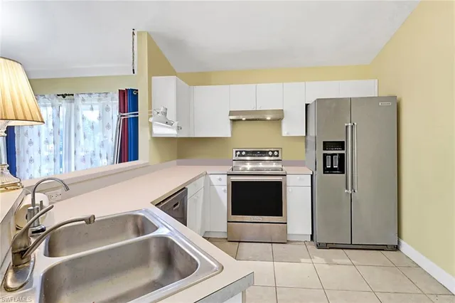 a kitchen with a sink cabinets and stainless steel appliances