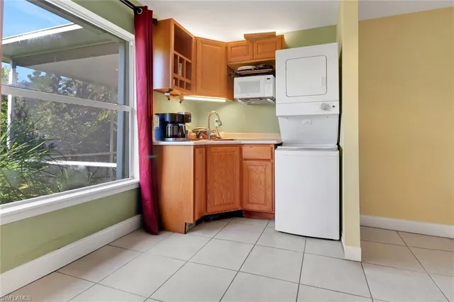 a kitchen with a refrigerator and window
