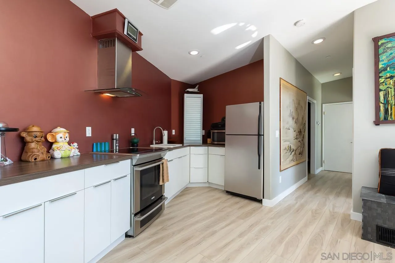 34747 Yuma Road Julian, CA 92036 - Photo 9 of 26 a kitchen with granite countertop a refrigerator oven a sink dishwasher and wooden cabinets with wooden floor