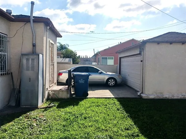 a couple of cars parked in front of a house