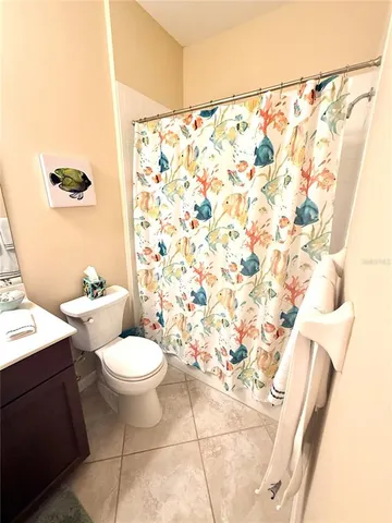 a dining room with furniture and a floor to ceiling window