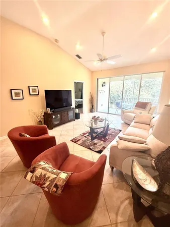 a dining room with furniture and a floor to ceiling window