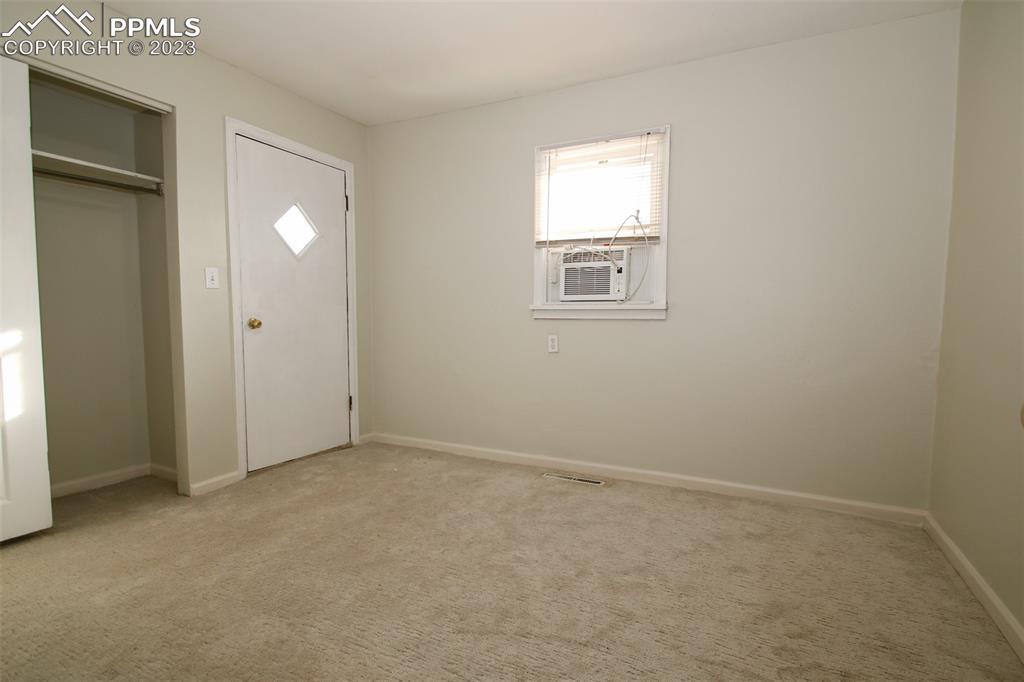 915 Alexander Road Colorado Springs, CO 80909 - Photo 12 of 24 an empty room with windows and closet