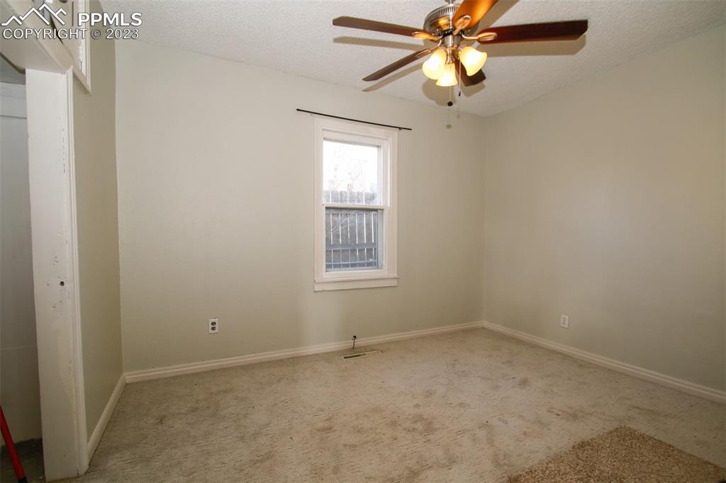 915 Alexander Road Colorado Springs, CO 80909 - Photo 13 of 24 a view of an empty room with a window