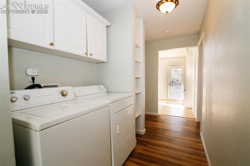 915 Alexander Road Colorado Springs, CO 80909 - Photo 16 of 24 a view of washer and dryer with wooden floor