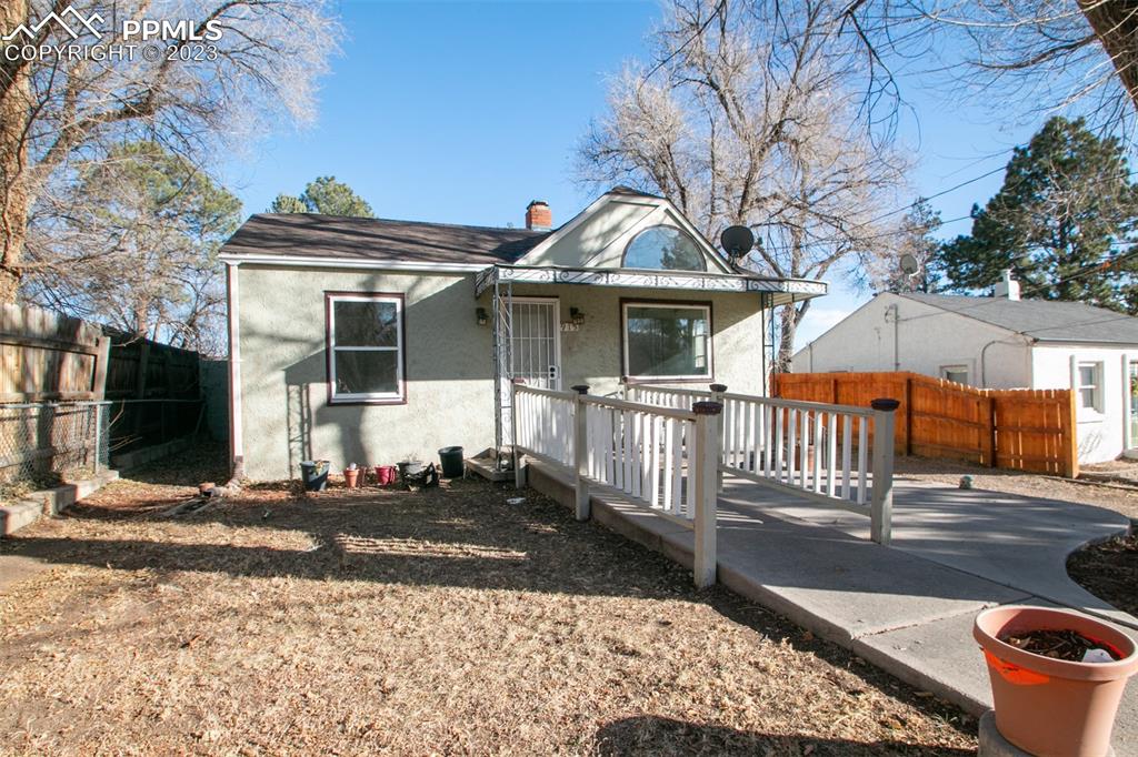 915 Alexander Road Colorado Springs, CO 80909 - Photo 3 of 24 a front view of a house with a yard