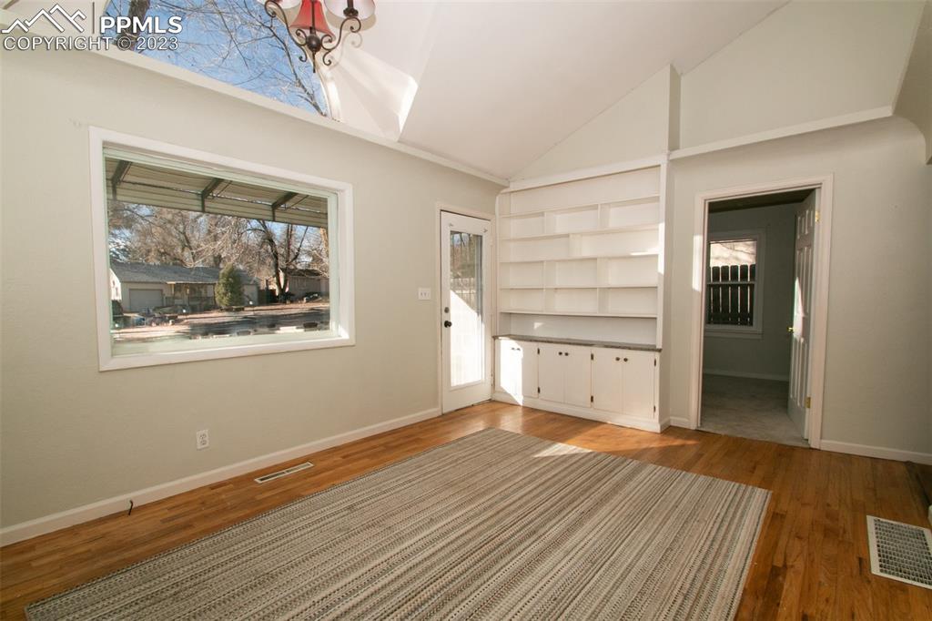 915 Alexander Road Colorado Springs, CO 80909 - Photo 7 of 24 a view of empty room with wooden floor and fan
