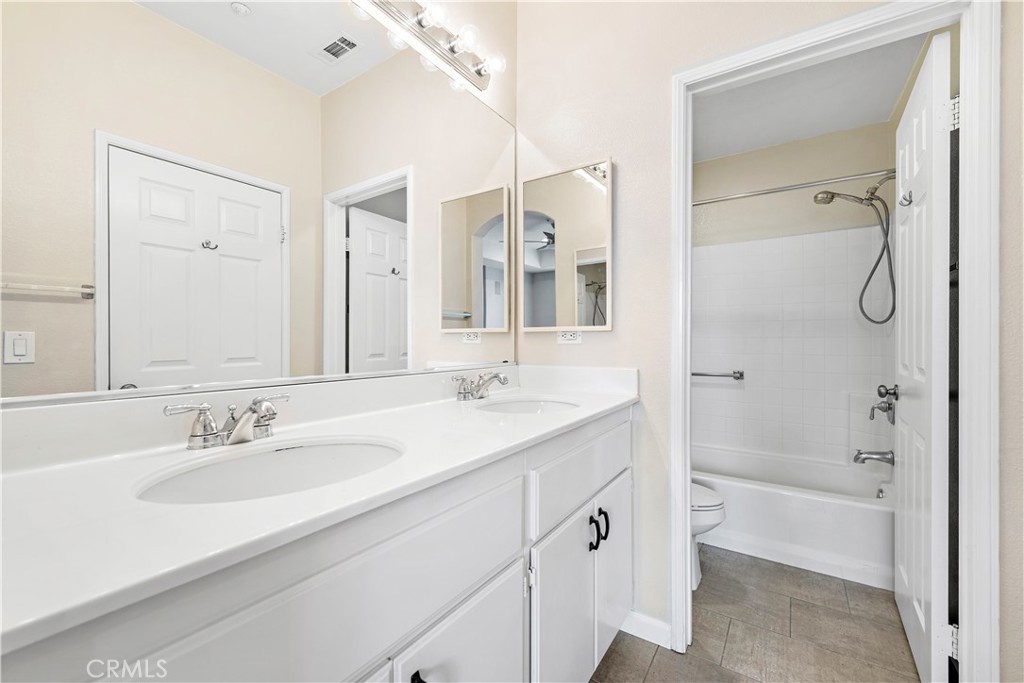 158 North Brea Boulevard Brea, CA 92821 - Photo 17 of 20 a bathroom with a granite countertop sink two mirror and a bathtub