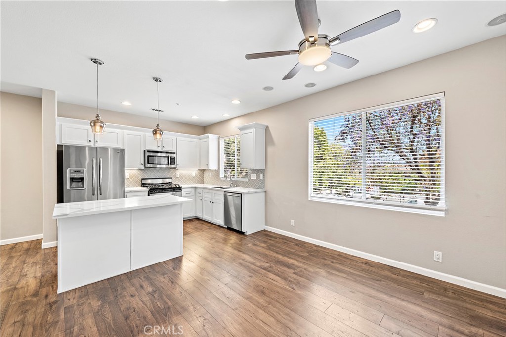 158 North Brea Boulevard Brea, CA 92821 - Photo 8 of 20 a large white kitchen with kitchen island a stove a sink cabinets and wooden floor