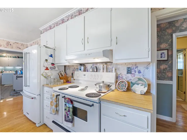 a kitchen with cabinets and chairs