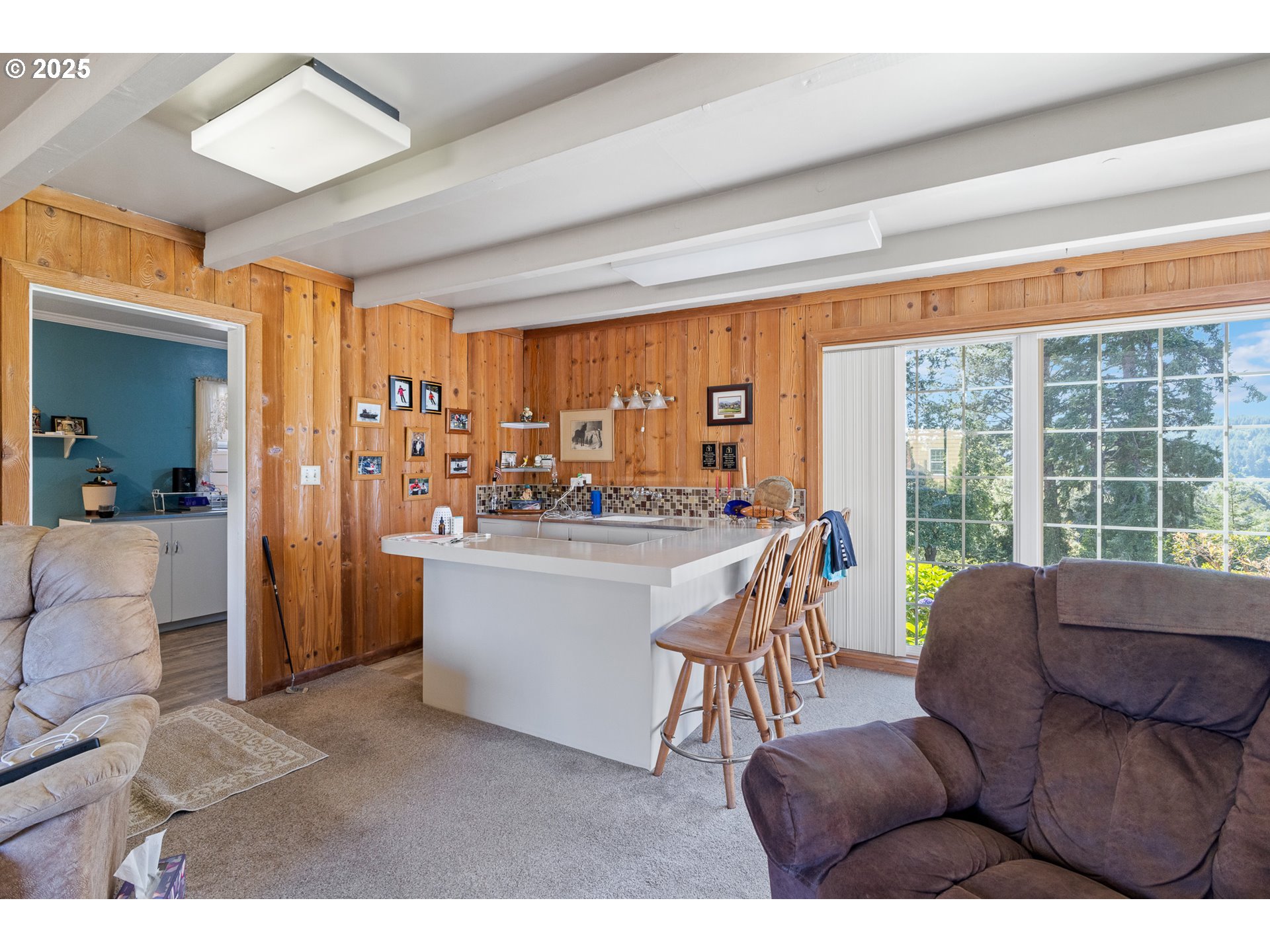 1211 Fairview Street Myrtle Point, OR 97458 - Photo 25 of 48 a living room with furniture a large window and a chandelier