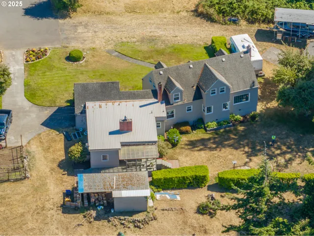 an aerial view of a house with a yard
