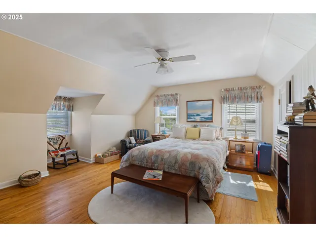 a view of a hallway with wooden floor and dining room