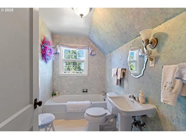 a view of a chairs and table in the backyard