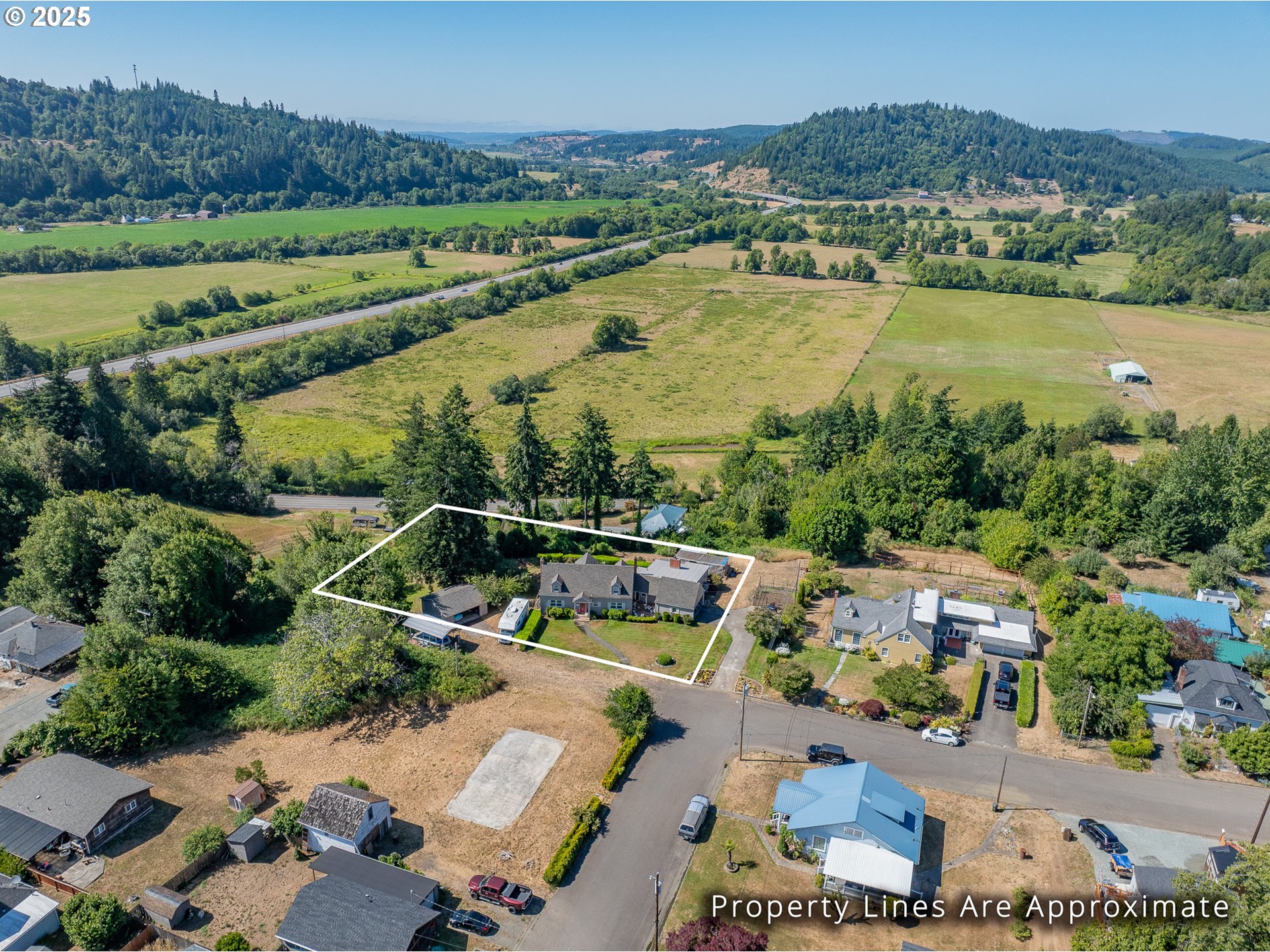 1211 Fairview Street Myrtle Point, OR 97458 - Photo 7 of 48 an aerial view of a city with lots of residential buildings and mountain view in back