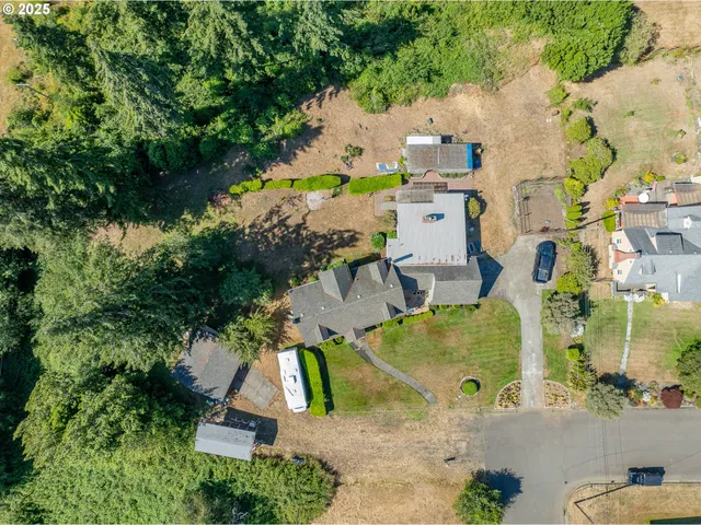 an aerial view of residential houses with outdoor space and parking