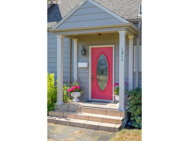 a living room with furniture a fireplace and a large window